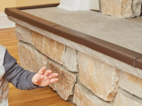 child's hand near a stone fireplace